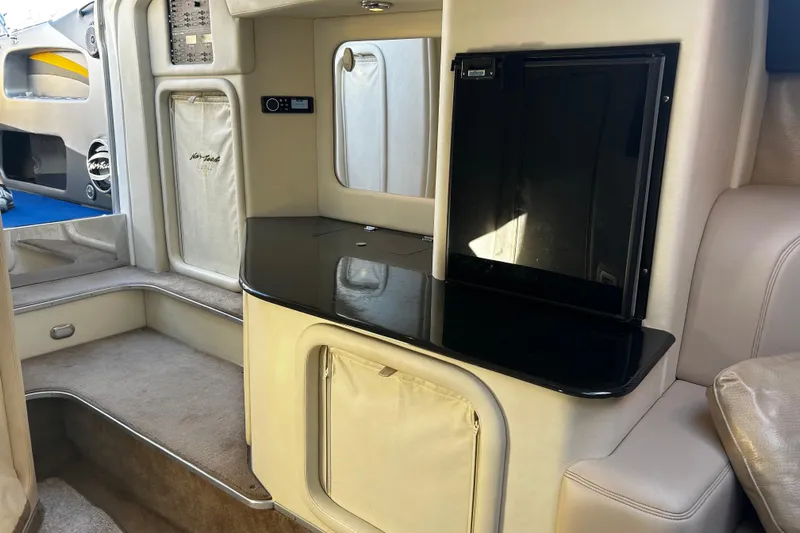  Yacht Photos Pics 2008 Nor-Tech 4300V boat interior with sleek black countertop and beige upholstery.