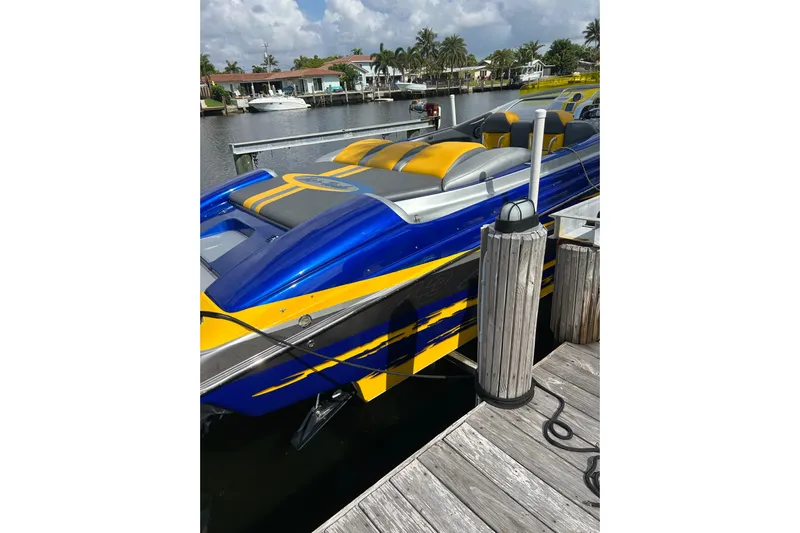  Yacht Photos Pics 2008 Nor-Tech 4300V powerboat docked, featuring vibrant blue and yellow design.