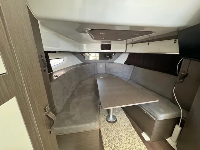 Fortuna Yacht Photos Pics Interior of 2022 Beneteau 32 Gran Turismo yacht, featuring a cozy seating area and table.
