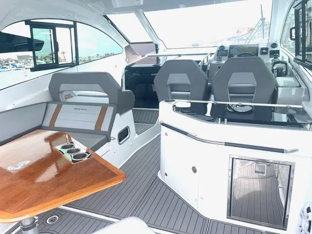 Fortuna Yacht Photos Pics Interior of 2022 Beneteau 32 Gran Turismo yacht with modern seating and wooden table.