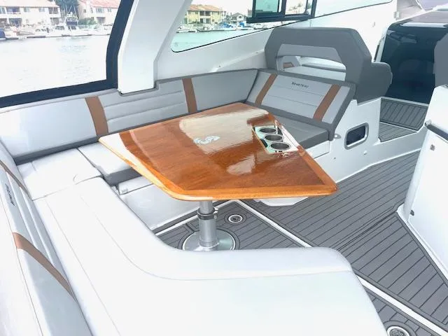 Fortuna Yacht Photos Pics Luxurious seating area on 2022 Beneteau 32 Gran Turismo yacht with wooden table.