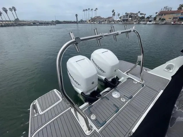 Fortuna Yacht Photos Pics 2022 Beneteau 32 Gran Turismo with dual Mercury outboard engines on a calm waterfront.