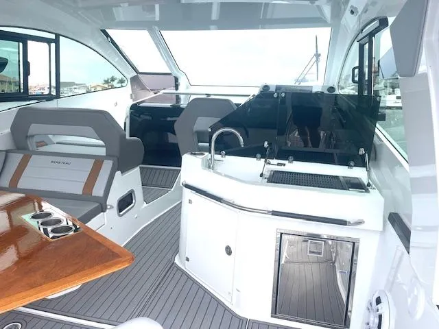 Fortuna Yacht Photos Pics Interior of 2022 Beneteau 32 Gran Turismo yacht with modern seating and kitchenette.