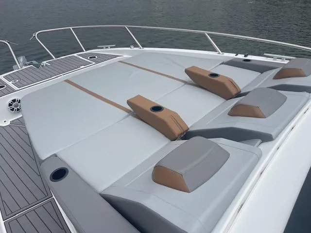 Fortuna Yacht Photos Pics 2022 Beneteau 32 Gran Turismo boat deck with cushioned seating and cup holders.