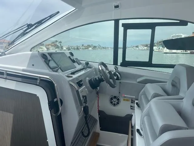 Fortuna Yacht Photos Pics Interior of 2022 Beneteau 32 Gran Turismo yacht with modern helm and seating.