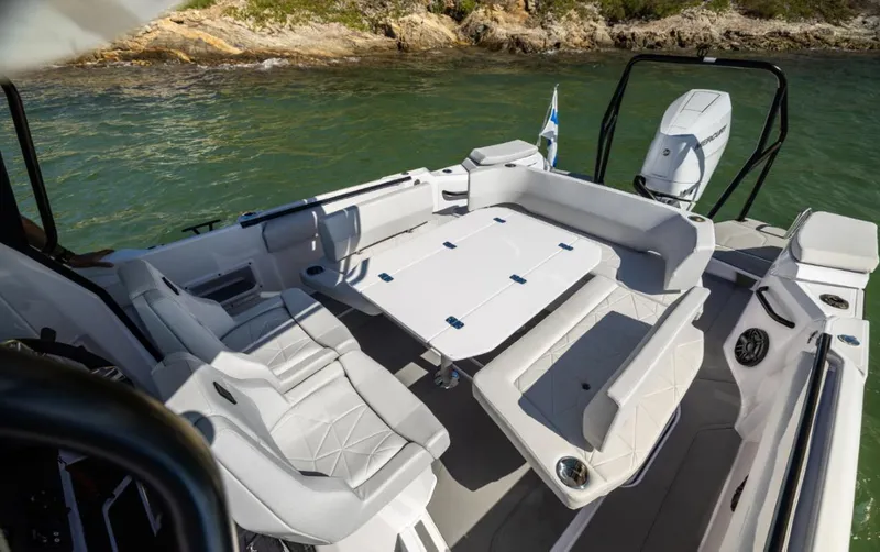  Yacht Photos Pics 2025 Axopar 29 CCX boat interior with seating and table on water.