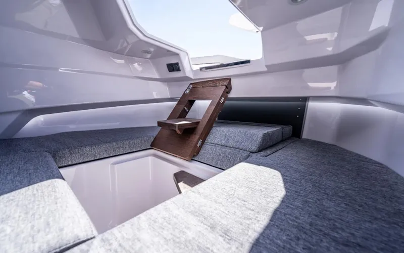  Yacht Photos Pics 2025 Axopar 29 CCX cabin interior with gray cushions and wooden accents.