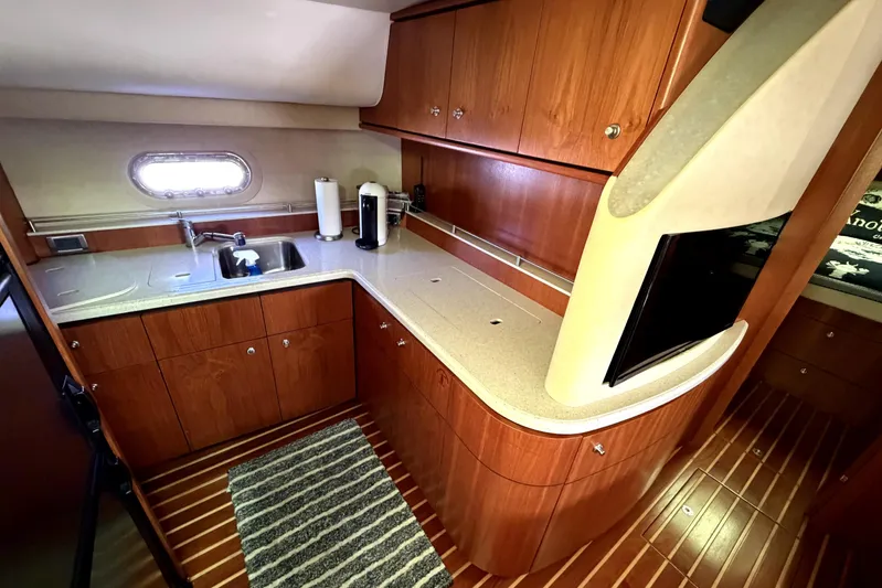  Yacht Photos Pics 2008 Tiara Yachts 4300 Sovran galley with wood cabinetry and modern appliances.