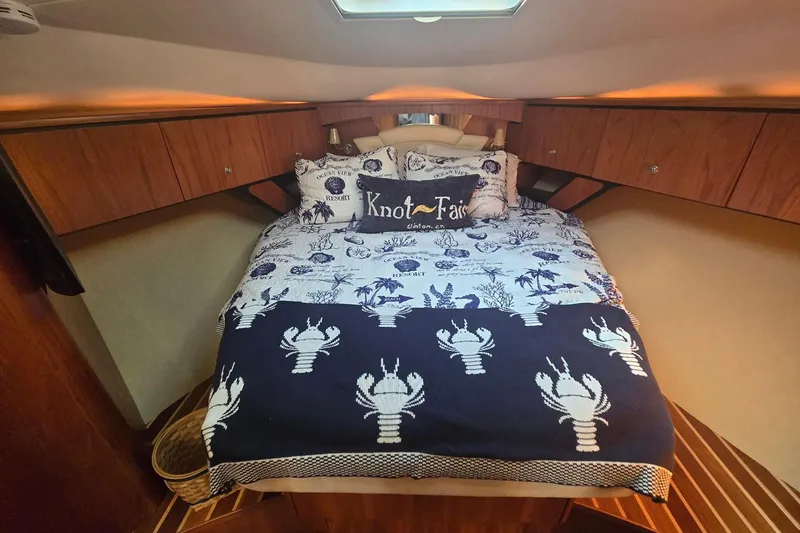  Yacht Photos Pics Cozy cabin interior of 2008 Tiara Yachts 4300 Sovran with nautical-themed bedding.
