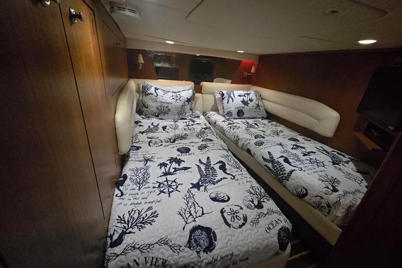  Yacht Photos Pics Luxurious 2008 Tiara Yachts 4300 Sovran cabin with twin beds and nautical-themed bedding.