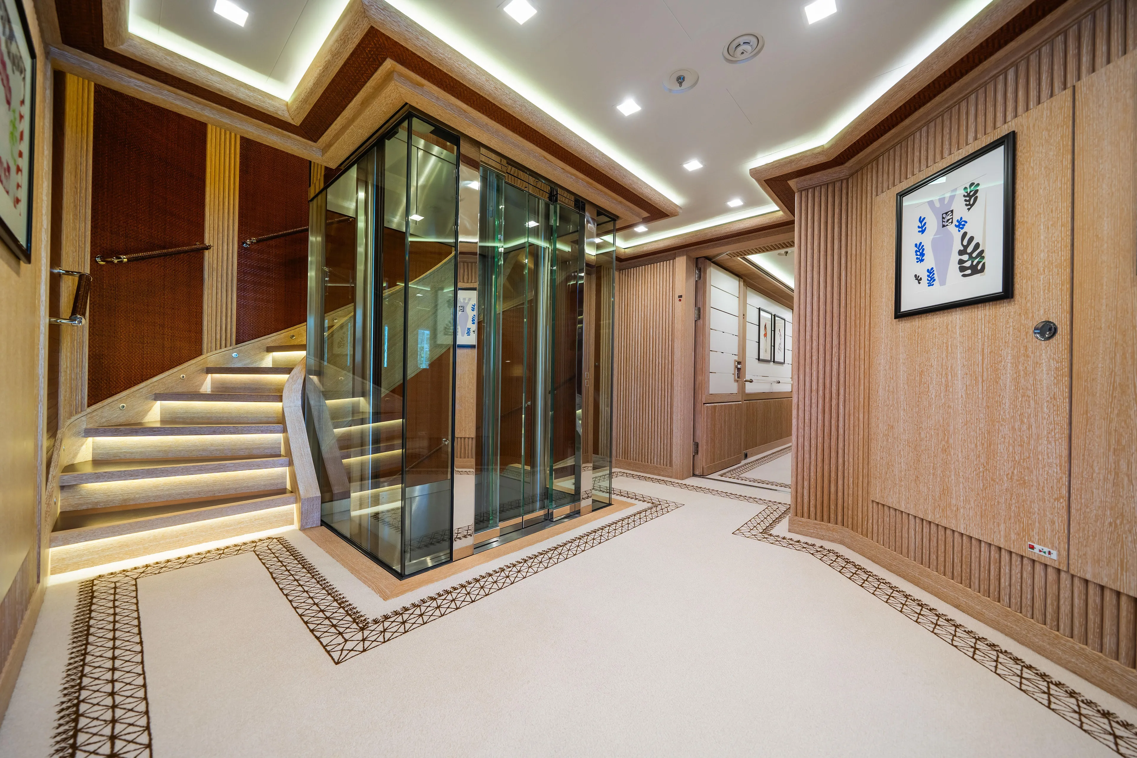 Axioma Yacht Photos Pics Luxurious interior of 2013 Dunya Yacht featuring elegant staircase and modern glass elevator.