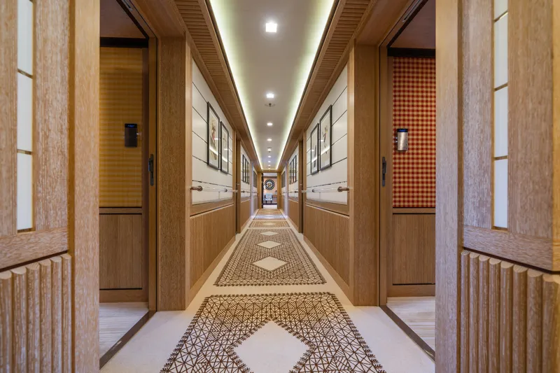 Axioma Yacht Photos Pics Luxurious hallway interior of 2013 Dunya Yacht, featuring elegant wood paneling and geometric carpet design.