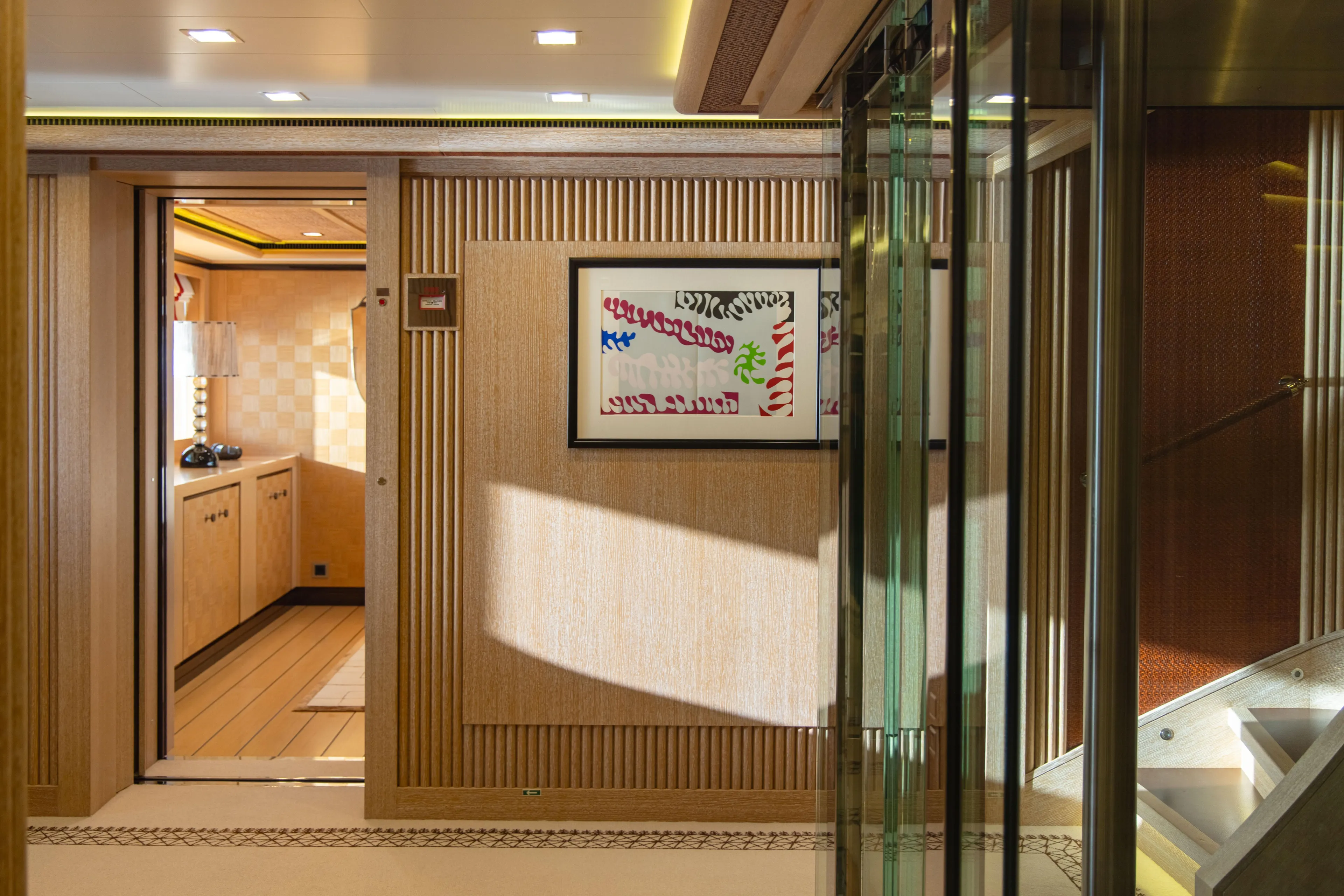 Axioma Yacht Photos Pics Luxurious interior of 2013 Dunya Yacht featuring elegant wood paneling and modern artwork.