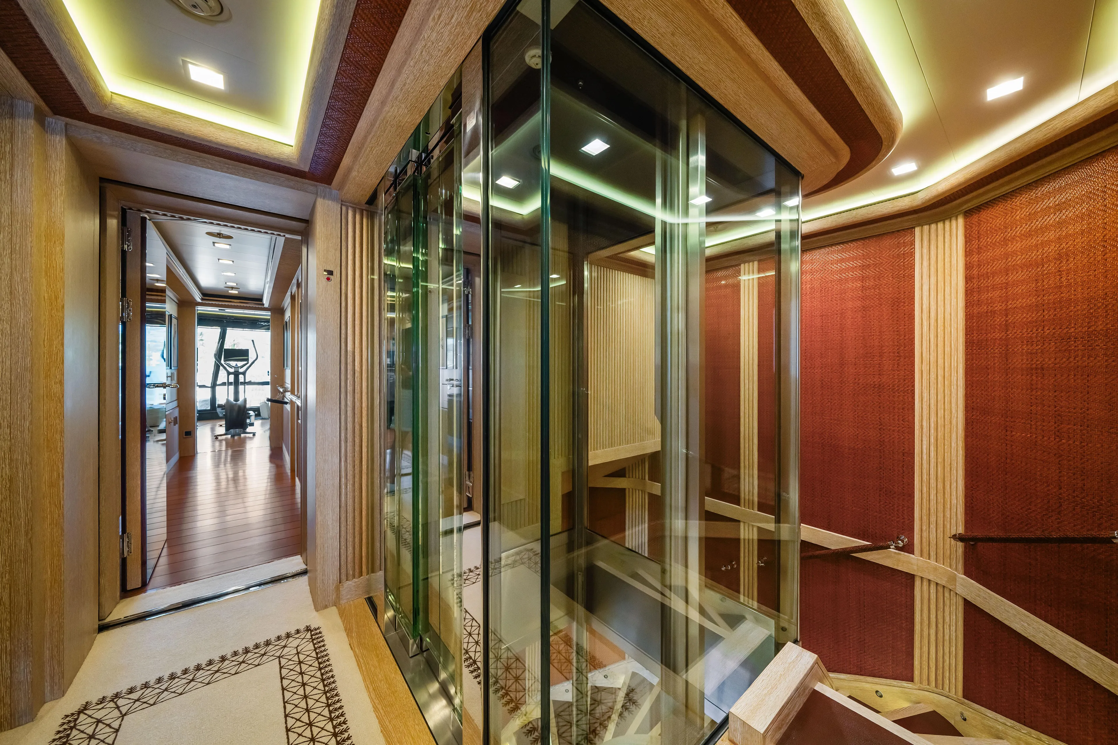 Axioma Yacht Photos Pics Luxurious interior of 2013 Dunya Yacht featuring glass elevator and modern gym equipment.