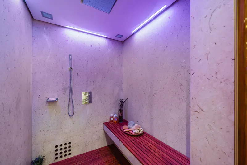Axioma Yacht Photos Pics Luxurious shower area on 2013 Dunya Yacht with modern lighting and wooden bench.