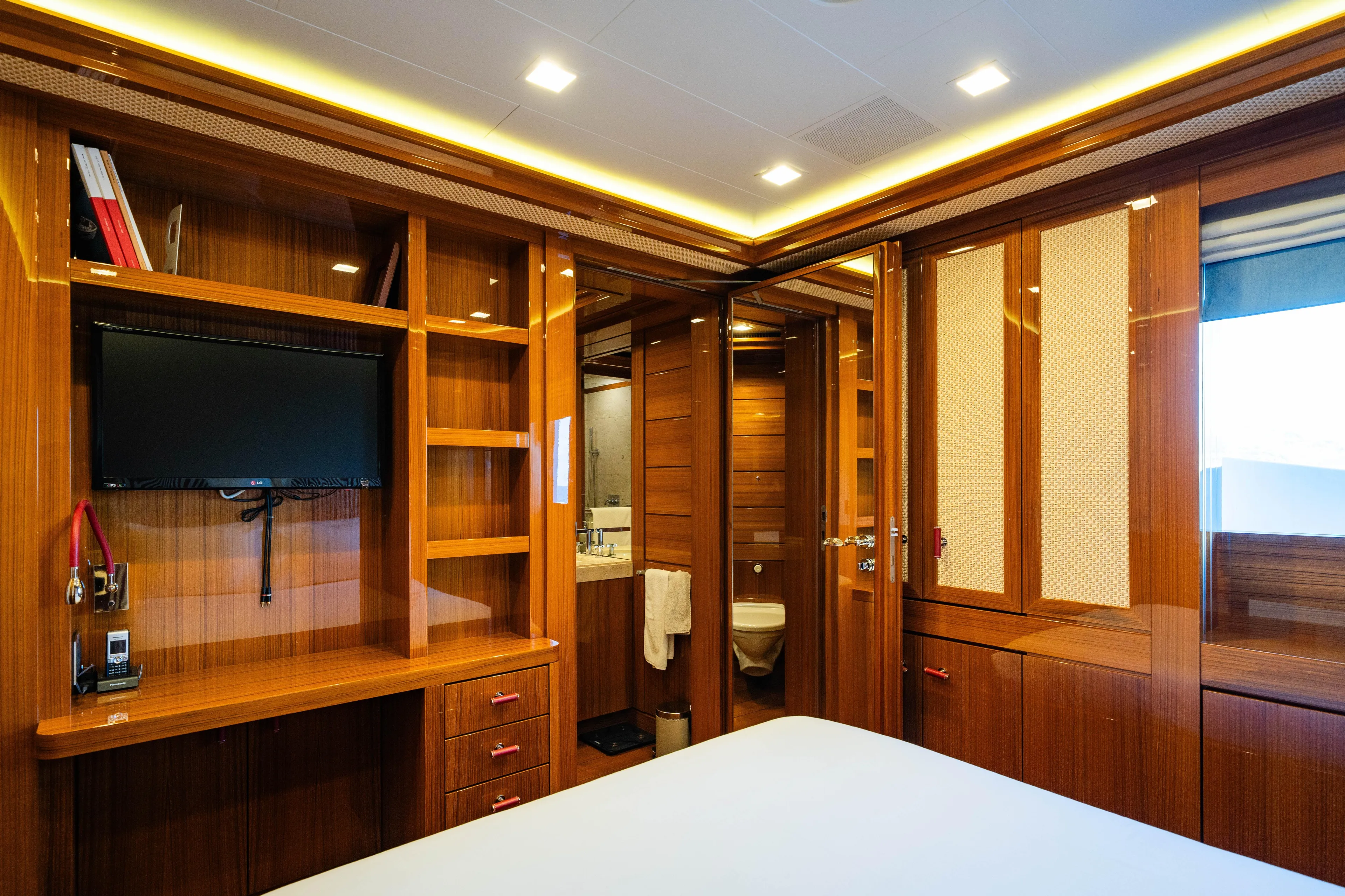 Axioma Yacht Photos Pics Luxurious 2013 Dunya Yacht interior with wood paneling, TV, and ensuite bathroom.