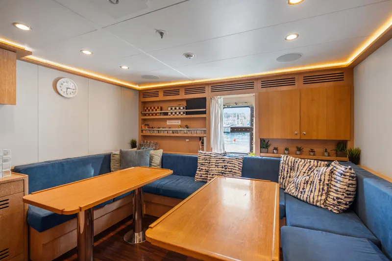 Axioma Yacht Photos Pics Luxurious 2013 Dunya Yacht interior with cozy seating, wooden tables, and elegant decor.