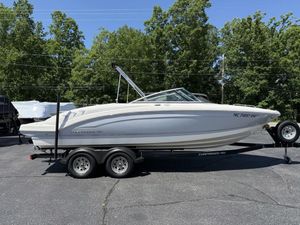 2022 Chaparral 23 SSi boat on trailer, parked outdoors with trees in background.