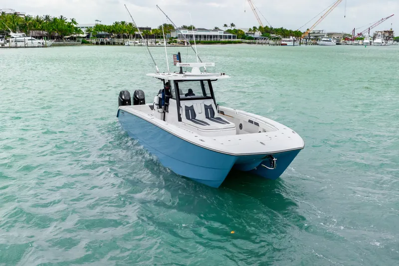 Kroppdustr Yacht Photos Pics 2023 Invincible 37 Catamaran cruising on turquoise waters.