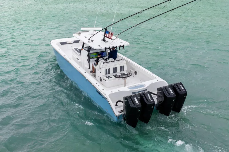 Kroppdustr Yacht Photos Pics 2023 Invincible 37 Catamaran with triple outboard engines on turquoise water.