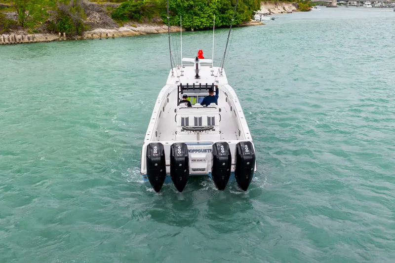 Kroppdustr Yacht Photos Pics 2023 Invincible 37 Catamaran with quad engines cruising in turquoise waters.