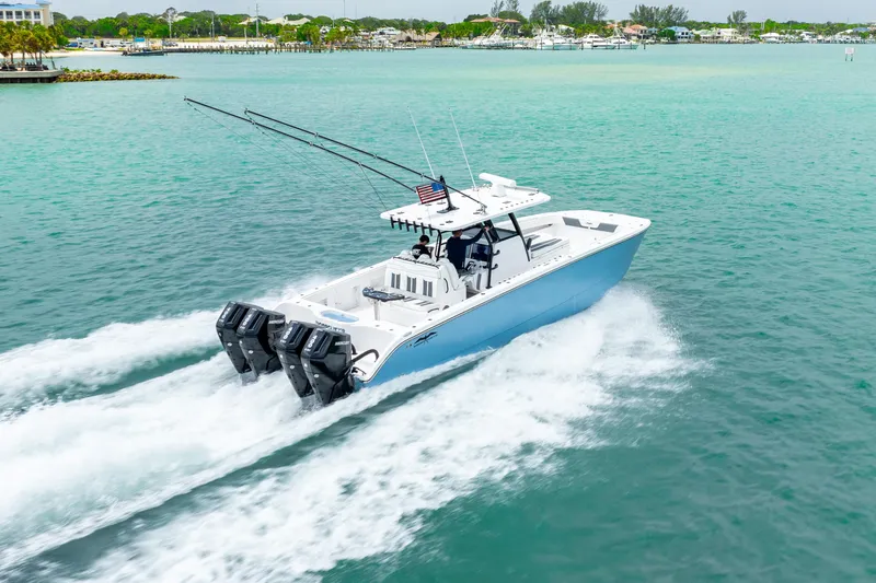 Kroppdustr Yacht Photos Pics 2023 Invincible 37 Catamaran cruising on turquoise waters near the coast.
