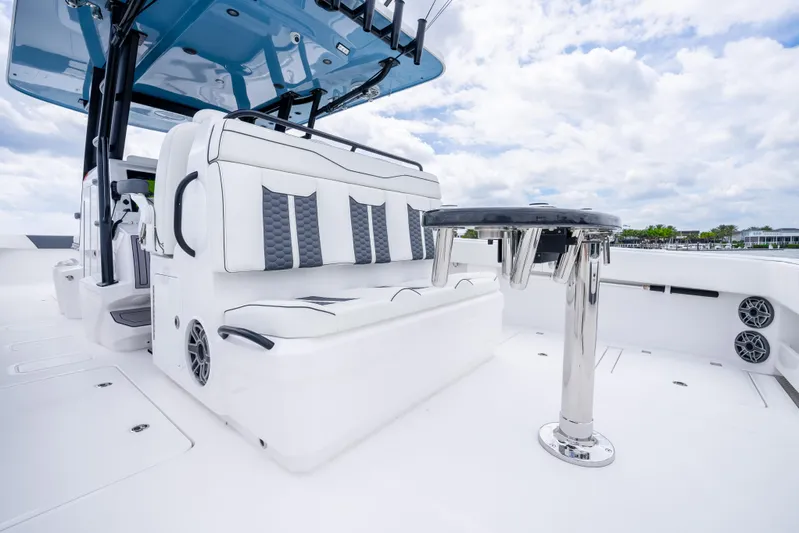 Kroppdustr Yacht Photos Pics 2023 Invincible 37 Catamaran with white seating and stainless steel table on deck.