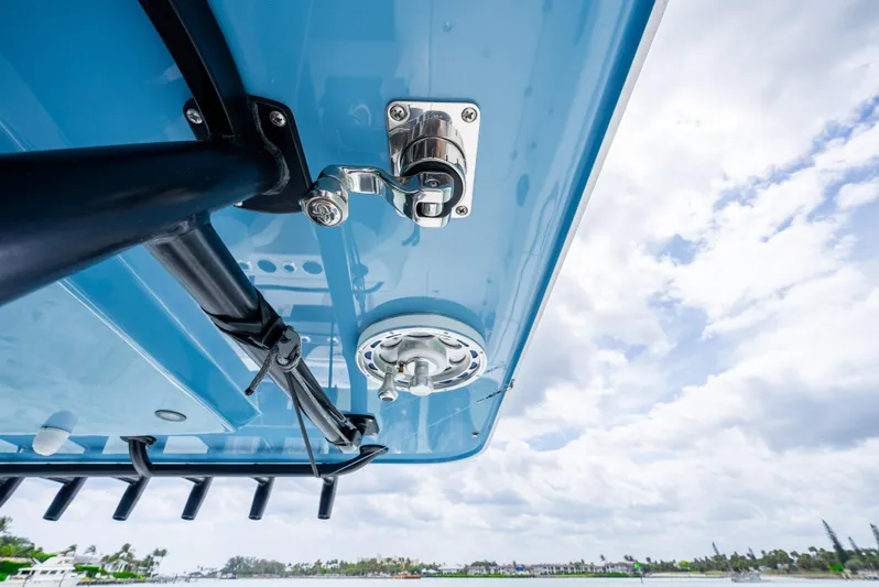 Kroppdustr Yacht Photos Pics 2023 Invincible 37 Catamaran, underside view with fishing rod holders and blue sky background.