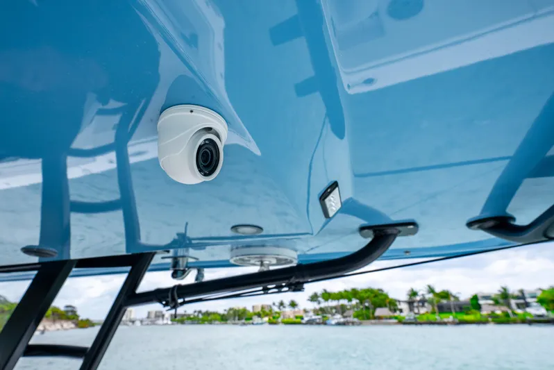 Kroppdustr Yacht Photos Pics Security camera on 2023 Invincible 37 Catamaran, blue canopy, waterfront background.