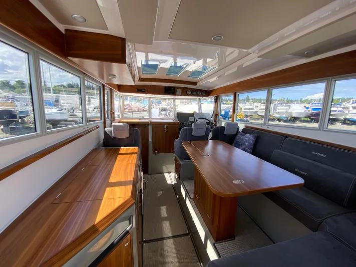 Ursa Yacht Photos Pics Interior of 2019 Sargo 36 Explorer boat with wooden finishes and spacious seating area.