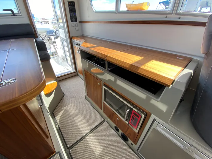Ursa Yacht Photos Pics Interior of 2019 Sargo 36 Explorer boat with wooden cabinetry and modern appliances.