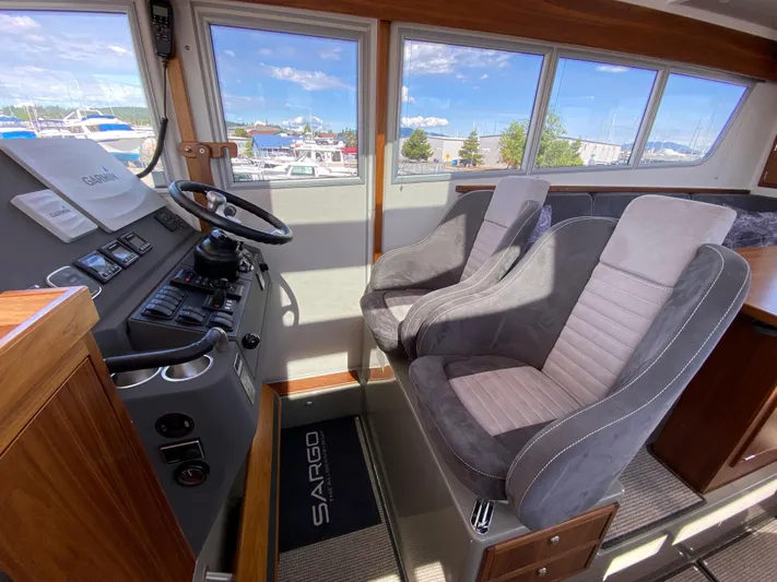 Ursa Yacht Photos Pics Interior of 2019 Sargo 36 Explorer boat with steering wheel and two seats.