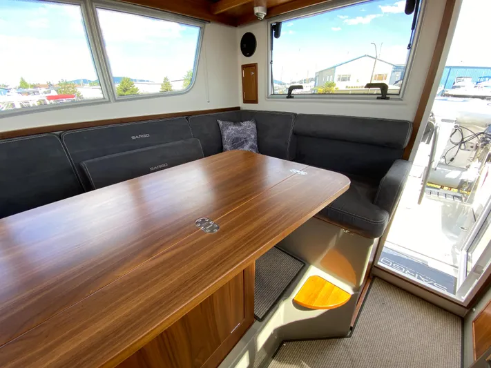 Ursa Yacht Photos Pics Interior of 2019 Sargo 36 Explorer with wooden table and cushioned seating.