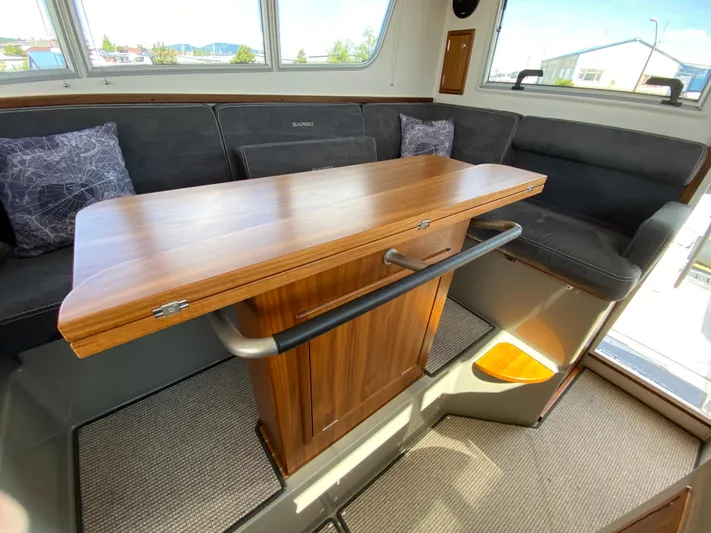Ursa Yacht Photos Pics Interior of 2019 Sargo 36 Explorer with wooden table and cushioned seating.