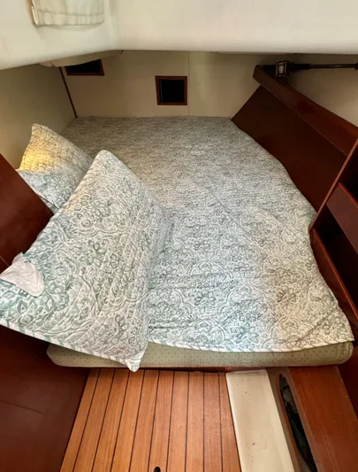 Yumi III Yacht Photos Pics Cozy cabin interior of 2005 Beneteau 423 sailboat with patterned bedding.
