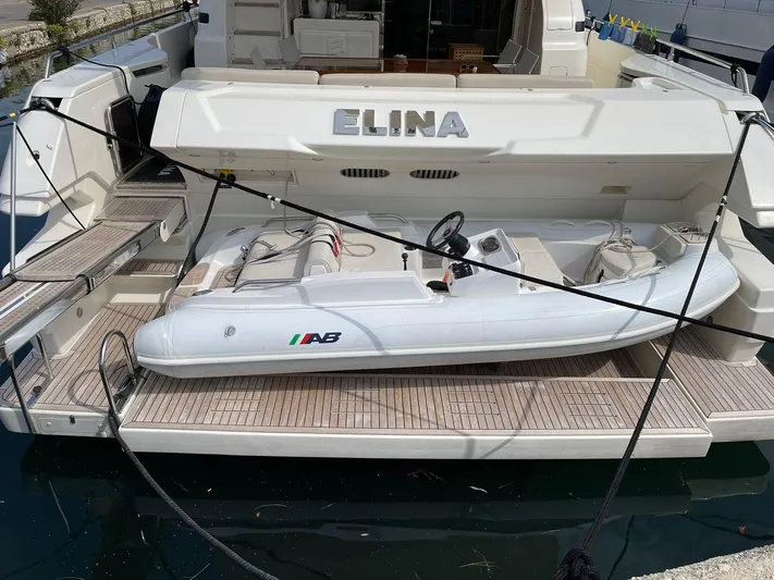  Yacht Photos Pics Ferretti Yachts 690 (2012) with tender on deck, docked at marina.