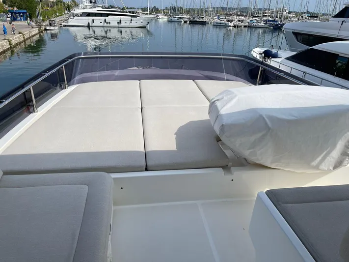  Yacht Photos Pics 2012 Ferretti Yachts 690 deck with sunbathing area, docked at marina.