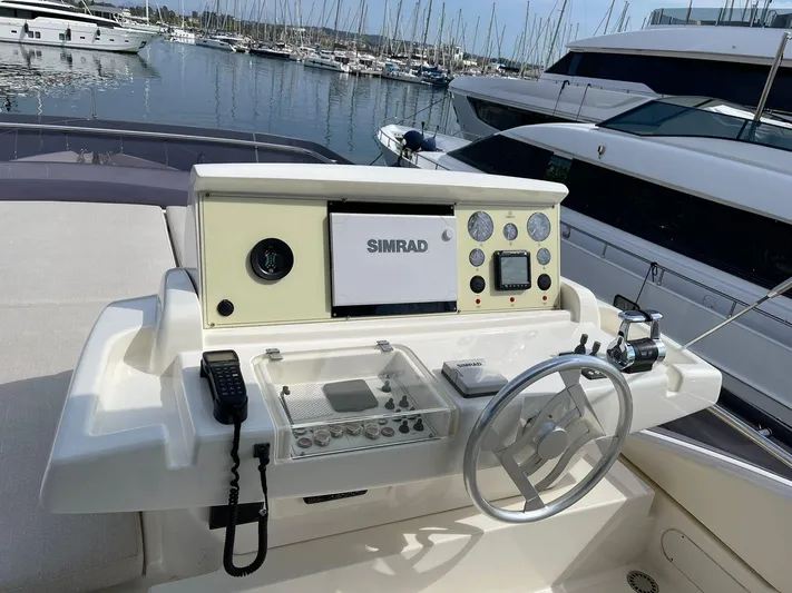  Yacht Photos Pics Helm of 2012 Ferretti Yachts 690 with navigation equipment and steering wheel.