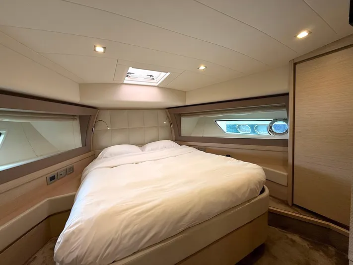  Yacht Photos Pics Luxurious bedroom interior of 2012 Ferretti Yachts 690 with modern design and cozy bedding.