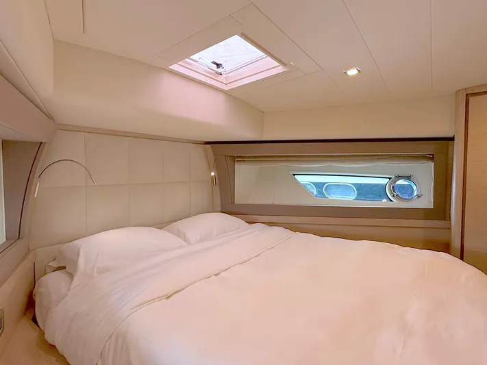  Yacht Photos Pics Luxurious bedroom interior of 2012 Ferretti Yachts 690 with skylight and modern design.