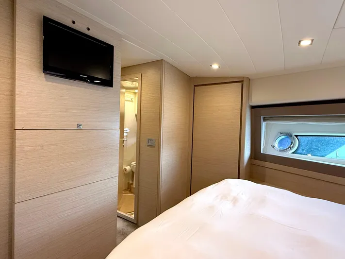  Yacht Photos Pics Luxurious bedroom interior of 2012 Ferretti Yachts 690 with TV and ensuite bathroom.