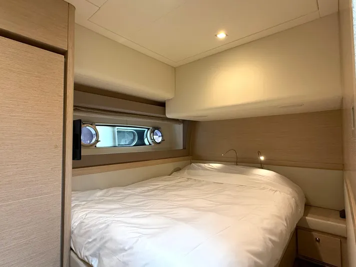  Yacht Photos Pics Luxurious cabin interior of 2012 Ferretti Yachts 690 with cozy bed and modern design.
