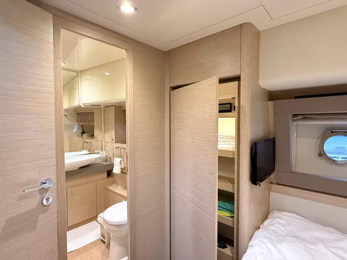 Yacht Photos Pics Luxurious interior of 2012 Ferretti Yachts 690, featuring a modern bathroom and cozy cabin.