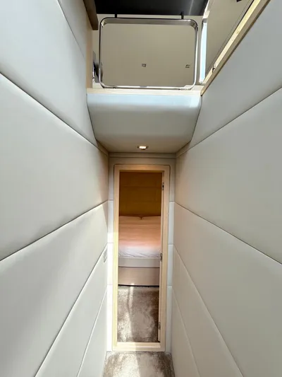  Yacht Photos Pics Narrow hallway inside 2012 Ferretti Yachts 690, leading to a cozy cabin.