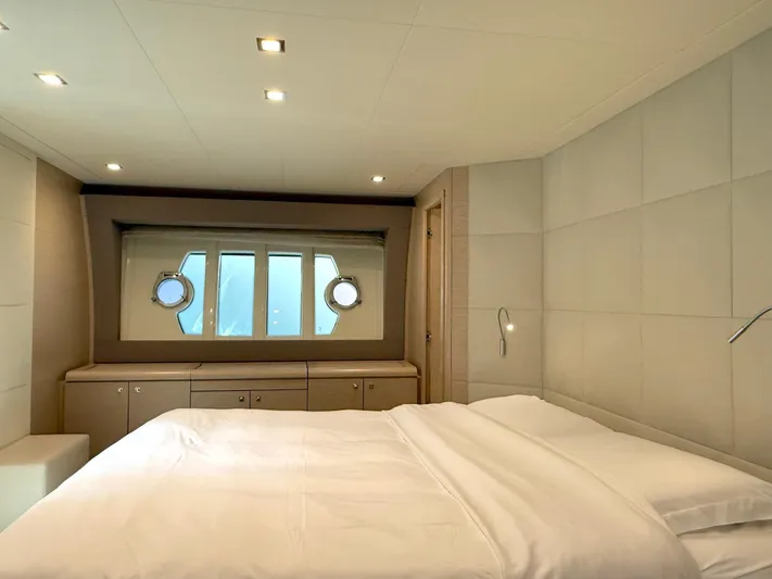  Yacht Photos Pics Luxurious bedroom interior of 2012 Ferretti Yachts 690 with modern design and porthole windows.