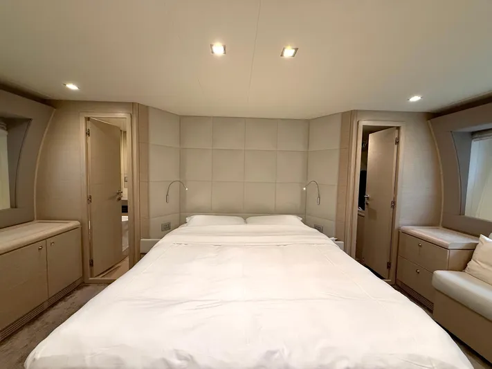  Yacht Photos Pics Luxurious bedroom interior of 2012 Ferretti Yachts 690 with modern design and ambient lighting.