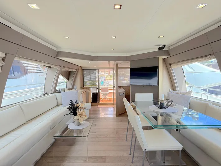  Yacht Photos Pics Luxurious interior of 2012 Ferretti Yachts 690 with modern seating and glass dining table.