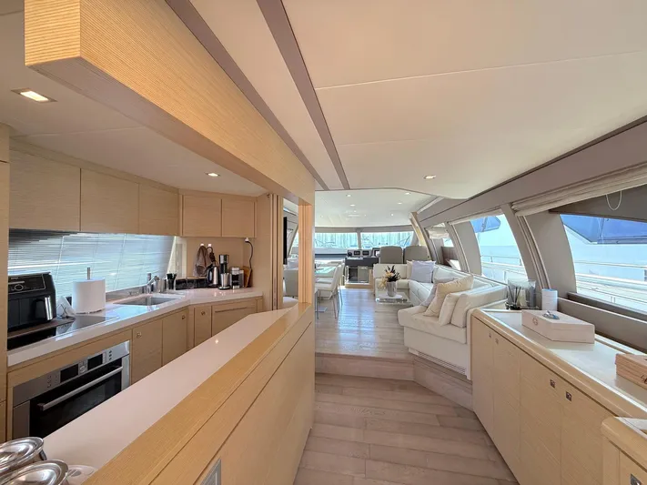  Yacht Photos Pics Luxurious interior of a 2012 Ferretti Yachts 690, featuring a modern kitchen and spacious lounge area.