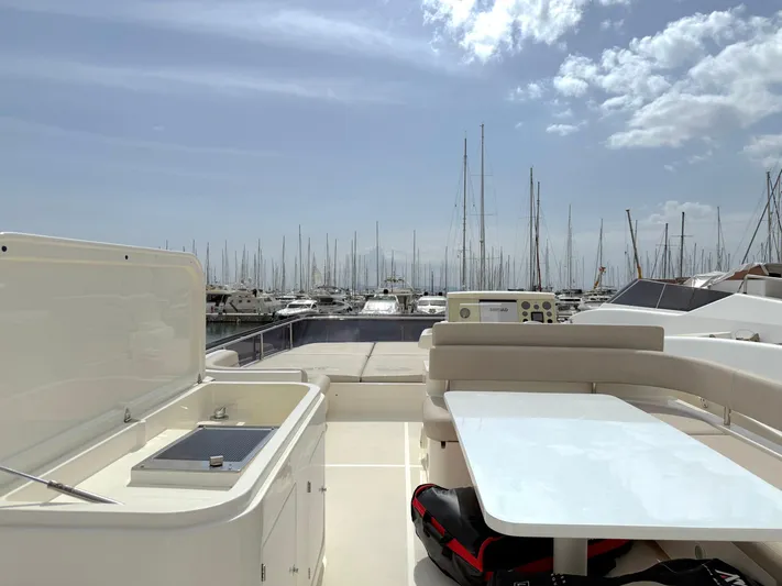  Yacht Photos Pics Luxurious 2012 Ferretti Yachts 690 deck with marina view under a partly cloudy sky.