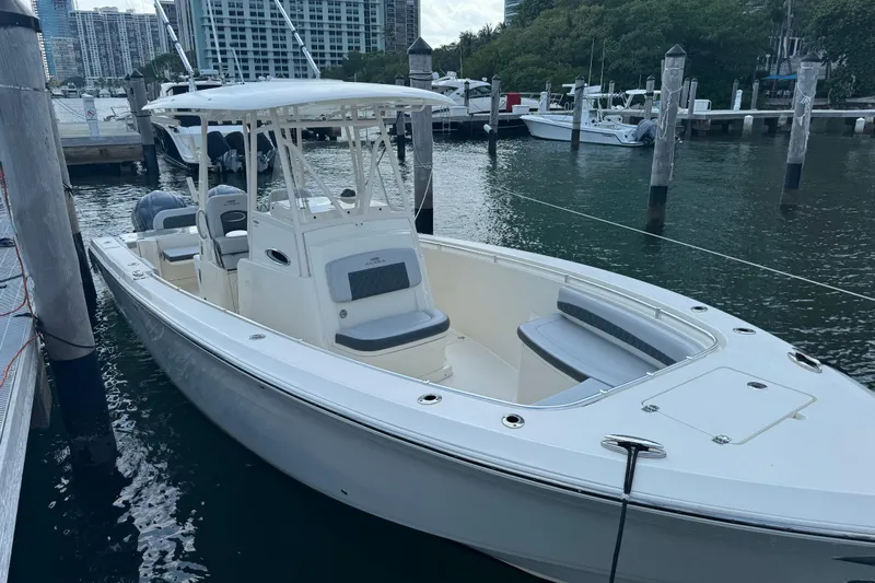 No Name Yacht Photos Pics 2018 Cobia 301 Center Console boat docked in marina, surrounded by water and other vessels.